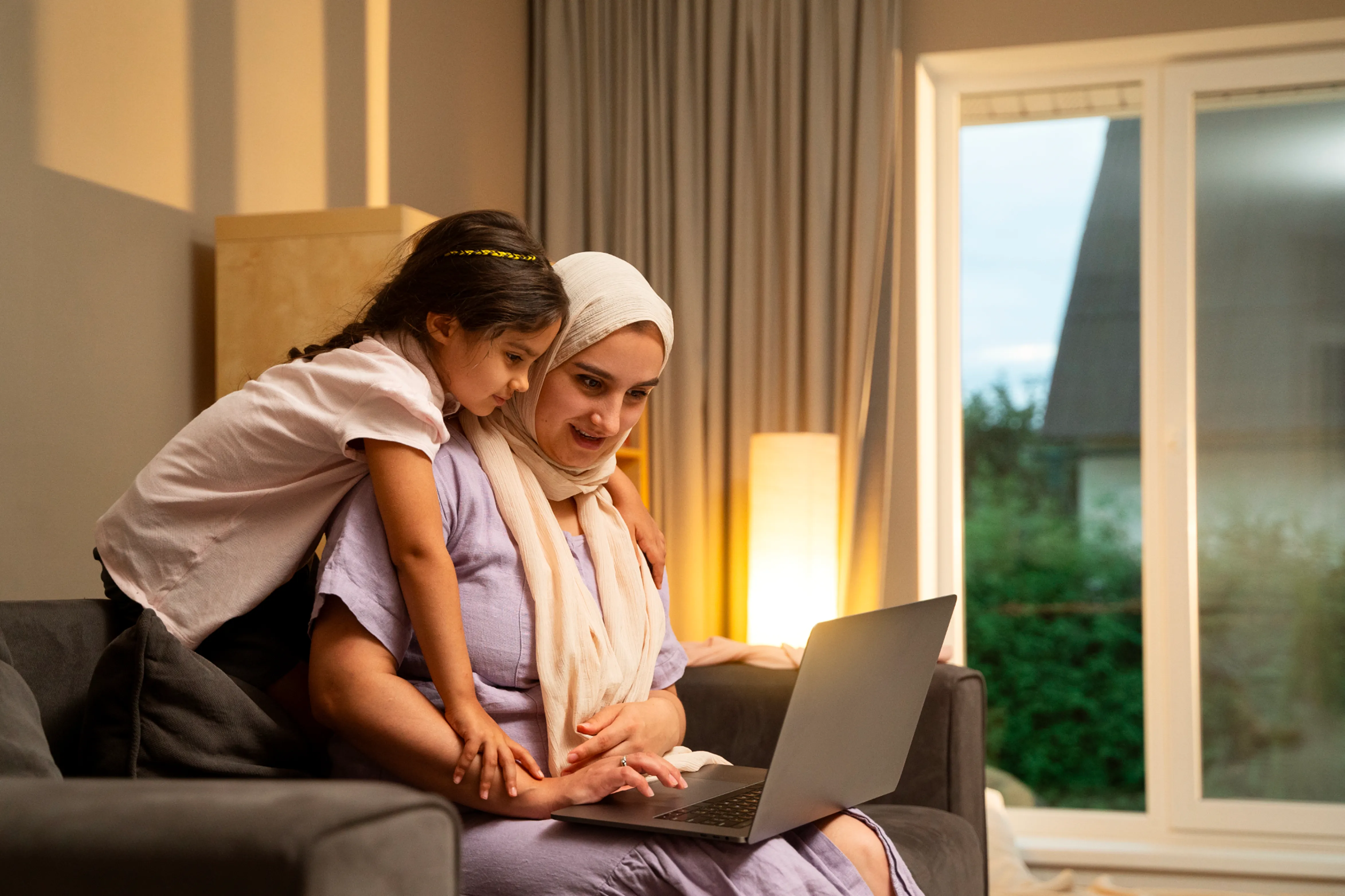 Mother and daughter looking at a laptop